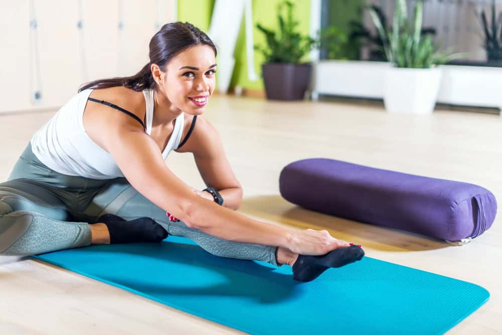 young woman excercising and stretching for flexibility