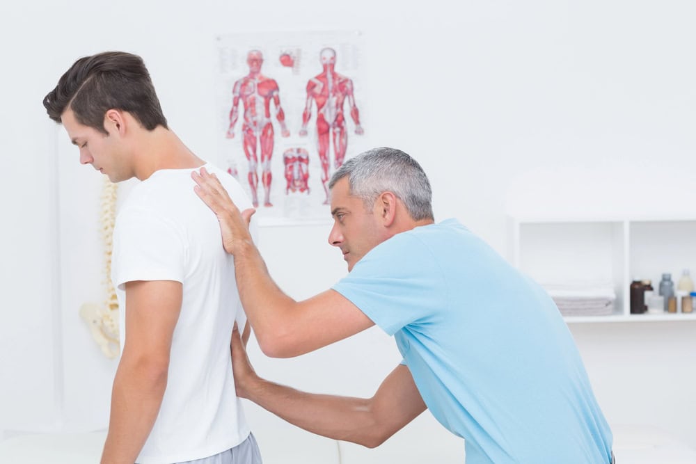 man having posture examined